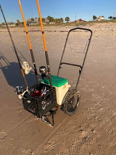 a cart with fishing rods attached to it on the beach