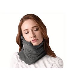 a woman wearing a neck gaiter with her eyes closed