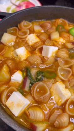 a pot filled with pasta and vegetables on top of a stove