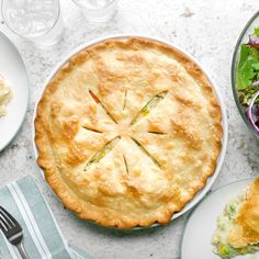 there is a pie and salad on the table