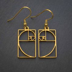 Fibonacci sequences are the basis for some of nature's most amazing creations. Besides being useful for architecture, financial market analysis, and various data algorithms, Fibonacci numbers are also spectacularly beautiful. These silver or gold colored steel earrings display the mathematical elegance of the Fibonacci sequence. Made from non-tarnishing metal, they are both delicate in design and very strong. They are hung from gold plated or stainless steel ear wires. For the ultimate classy in Modern Metal Jewelry, Cadmium-free, Geometric Gold Nickel-free Jewelry, Nickel-free Geometric Gold Jewelry, Gold Geometric Nickel-free Jewelry, Minimalist Spiral Metal Jewelry, Modern Gold Spiral Jewelry, Modern Jewelry With Unique Spiral Design, Modern Cadmium-free Earrings As A Gift, Geometric Matching Earrings Jewelry Gift