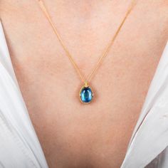 This iridescent Moonstone is formed into the shape of a small oval. We encased it in a handmade gold bezel with braided detail and prongs to showcase its swirling blue beauty. Technical Details Metal: 18k yellow goldMoonstone: 3.18 cts. Pendant Size (not including bail): 12mm x 9mmChain: can be worn at 16" and 18"Closure: lobster claspHandmade in New YorkStyle # N-3471-MO Elegant Jewelry With Blue Topaz Oval Cabochon, Handmade Yellow Gold Necklace With Oval Cabochon, Elegant Blue Topaz Oval Cabochon Jewelry, Blue Topaz Oval Pendant Jewelry, Blue Topaz Oval Cabochon Jewelry Gift, Gift Blue Topaz Oval Cabochon Jewelry, Oval Blue Topaz Yellow Gold Jewelry, Yellow Gold Necklace With Oval Cabochon Birthstone, Oval Yellow Gold Blue Topaz Jewelry