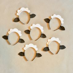 six pieces of paper cut out to look like sheeps with leaves on their ears