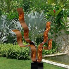 a metal sculpture in the middle of a garden