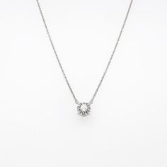 A very fine Tiffany & Co. diamond solitaire necklace.  With a large, nearly 1 ct brilliant round cut diamond set in a platinum solitaire pendant setting.   Together with a signed Tiffany & Co. platinum chain and box.  (The pendant was converted from a Tiffany ring in the last 10 years. We're including the original setting with as well as the Tiffany paperwork and conversion paperwork we have from the owner.)  Diamond specifications Per Tiffany:  0.95 carats, I color, VS2 clarity  Simply one of t Timeless Silver Solitaire Necklace, Timeless Silver Round Cut Diamond Necklace, Timeless Silver Diamond Necklace With Round Cut, Silver Round Cut Diamond Necklace Timeless Style, Minimalist Brilliant Cut Diamond Necklace For Formal Events, Minimalist Brilliant Cut Diamond Necklace For Formal Occasions, Timeless Silver Diamond Cut Necklace, Elegant Silver Solitaire Necklace With Single Cut Diamonds, Timeless Silver Diamond Necklace With Vvs Clarity