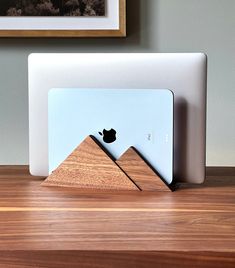 an apple computer sitting on top of a wooden desk