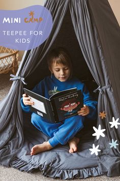 a little boy reading a book in a teepee for kids