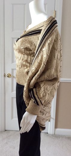 Vintage 1989 Moschino Couture gold lame knit sport wear influenced sweater twin set. The cardigan falls in a cocoon shape. Pull over V-neck is size Italian 40, USA 6, for a tight fit. Cardigan over it is size Italian 42, USA 8 for a looser top layer. Elegant statement piece that adds the whimsy of casual sportswear design. This set from 1989 is unworn from my private art collection. No snags or discoloration. Elegant Gold Sweater For Winter, Elegant Gold Winter Sweater, Gold Knit Sweater For Winter, Gold Knit Winter Sweater, Gold Long Sleeve Sweater, Sportswear Design, Fall Cardigans, Moschino Couture, Gold Lame