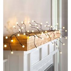 a wooden mantle with lights on it