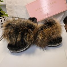 Ladies' Genuine Fur Slippers, Characterized By Their Plush Texture And Regal Appearance. These Slippers Feature A Black, Pliable Sole That Comfortably Accommodates Feet Sized 6 To 7, Making Them Suitable For Individuals With Small To Medium-Sized Feet. Additionally, I Have Similar Slippers In A Vibrant Multi-Colored Pink And Blue Combination, As Well As A Striking Neon Green Pair Adorned With Sparkling Embellishments Around The Edges. Winter Sandals With Faux Fur Lining And Round Toe, Brown Synthetic Slippers With Flat Heel, Synthetic Slippers With Faux Fur Lining And Round Toe, Brown Synthetic Flat Heel Slippers, Brown Synthetic Flat Slippers, House Shoes Slippers, Blue Combination, Asos Shoes, Satin Shoes