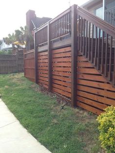 a brown wooden fence next to a house