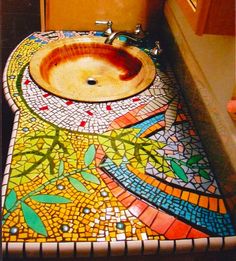 a bathroom sink with a mosaic design on it