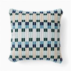 a blue and white pillow on a white background