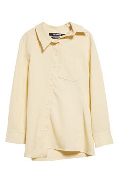 The asymmetric placket of this butter-yellow shirt shifts the collar, J-shaped chest pocket, hem and drape of the back box pleat slightly off-kilter. Asymmetric front-button closure Asymmetric point collar Long sleeves with one-button cuffs Chest patch pocket 88% viscose, 12% polyester Dry clean Imported Designer Clothing Jacquemus Shirt, Yellow Shirt, Butter Yellow, Yellow Shirts, Summer Fits, Box Pleats, Pale Yellow, Chest Pocket, Patch Pocket