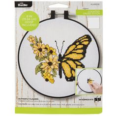 the cross stitch kit features a yellow butterfly and flowers