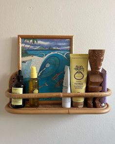 a shelf with various items on it and a painting in the corner behind it,