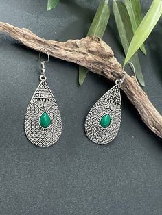 Indus Earrings : Back to our Roots. For the women who makes a statement.  An exclusive shop for earrings. Wear them with pride.  These are dangling drops style earrings . An unique handmade Indian style ethnic bohemian/ Tribal earrings in silver shade.  These earrings are made from high quality Tatanium / German silver material  which are hypoallergenic and free from corrosion & rusting. An uniquely crafted large teardrop earrings with emerald green stone  Notes : The product shipped will be same as shown in the picture, however the actual colours may vary slightly due to the natural lighting in the photography. We do not accept returns or refunds , however in case of any issues we will definitely try and resolve it. Bohemian Teardrop Danglers For Gifts, Bohemian Green Pierced Teardrop Earrings, Bohemian Green Teardrop Pierced Earrings, Nickel Free Teardrop Earrings For Festival, Nickel-free Teardrop Earrings For Festival, Bohemian Teardrop Earrings With Ear Wire, Bohemian Teardrop Earrings With Matching Pair, Bohemian Teardrop Pierced Earrings, Festival Teardrop Earrings