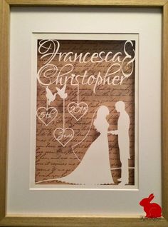 a paper cutout of a bride and groom holding hands in front of a love letter