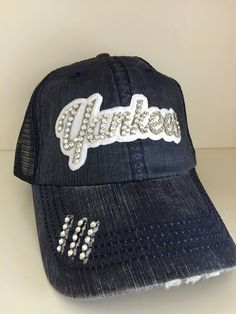 a black hat with the word charlotte written on it and some beads around the brim