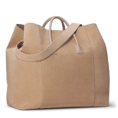 Practical and stylish, this oversize weekender bag is ideal for a getaway. Expertly made to the highest standards in Florence, Italy, it has shoulder straps or a longer detachable strap can be used for ease of transport. Suede Nappa leather Inside pocket Dimensions: 17.7"l x 9.8"w x 14.6"h Comes in a protective dust bag Made in Italy Care instructions: Only clean with a dry brush or dry cloth | AERIN Suede Oversized Weekender size 17.7"l x 9.8"w x 14.6"h | AERIN Suede Oversized Weekender Bag in Dry Brush, Croc Leather, Florence Italy, Office Accessories, Fall Shopping, Bag Bag, Nappa Leather, Leather Mini, Weekender Bag