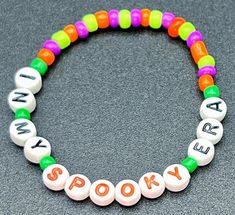 a beaded bracelet with words that spell out the word spooky on it