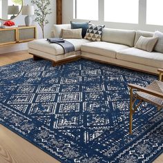 a living room with a large blue rug on the floor