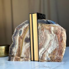 two bookends made out of marble sit on a table