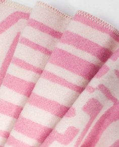 pink and white striped towel folded on top of each other