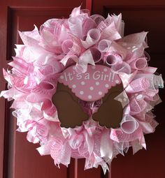 a pink and brown minnie mouse wreath with it's a girl