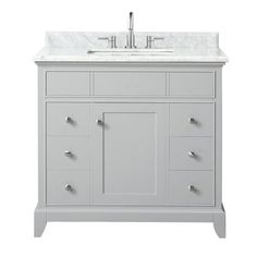 a white bathroom vanity with marble top and drawers