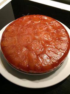 a round cake sitting on top of a white plate