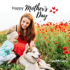 a woman and child are sitting in the grass with a dog