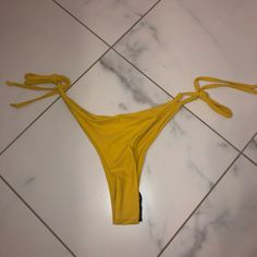 Yellow Bikini Bottoms Never Worn. Still Have Tag And Sticker On. Very Cheeky Fitted String Bottoms For Pool, Summer String Bottoms For Swimming, String Bottoms For Poolside And Beach Season, Party Beachwear String Swimwear, Yellow Tie-side Swimming Bottoms, Yellow Tie-side Beachwear Bottoms, Yellow Tie-side Bottoms For Beach Season, Trendy Yellow Bottoms For Pool, Yellow Stretch Swimwear For Party