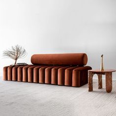 a living room with a couch, table and potted plant