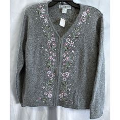 This Vintage Dress Barn Cardigan Is A Stunning Addition To Any Wardrobe. The Gray Silk, Nylon, And Angora Material Makes For A Luxurious Feel And The Embroidered Floral Accents Add A Touch Of Elegance. The Full Zip And Shoulder Pads Make It A Versatile Piece For Any Occasion. This Cardigan Is A Size M And Has Long Sleeves, Perfect For The Colder Months. The Rabbit Medallion Adds A Unique Touch To This Vintage Piece. Overall, This Dress Barn Cardigan Is A Must-Have For Any Fashion-Forward Woman. Embroider Jacket, Knit Shirts, Gray Silk, Dress Barn, Embroidered Jacket, The Rabbit, The Gray, Knit Shirt, Vintage Dress