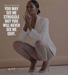 a woman kneeling on the ground with her hands clasped to her chest, in front of a beige background