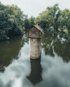 an old water tower in the middle of a river