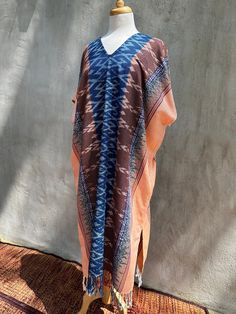 You will look fabulous in this truly unique hand made kaftan from hand woven (with hand woven pattern!) and hand dyed thread. The kaftan feels as good as it looks with soft and graceful drape. Pefect for evening wear, events and out and about it is made with care and long lasting quality. Traditional Ikat Print Maxi Kaftan, Traditional Maxi Kaftan With Ikat Print, Traditional Ikat Print Tunic Kaftan, Bohemian Handwoven Kaftan For Festivals, Bohemian Long Sleeve Handloom Kaftan, Bohemian Kaftan With Ikat Print And Kimono Sleeves, Bohemian Maxi Kaftan With Batik Print, Traditional Thobe With Kimono Sleeves For Beach, Bohemian Long Sleeve Ikat Print Kaftan