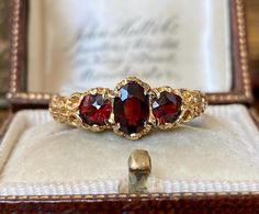 This item is a beautiful vintage 375 9ct gold triple garnet gemstone ring  The ring measures approx :- UK size - 'O' US size - '7.5' The ring face measures 1.3cms by 0.7cms The ring weighs approximately - 2.58gms.   Fully English hallmarked for 375 9ct gold.  Please see photos for a more detailed description. Box in photographs not included in the sale.  Any wear & tear to be expected on a vintage item. Vintage Ruby Engagement Ring, Vintage Ruby Engagement Rings, Vintage Gold Wedding Rings, Ruby Engagement Ring Vintage, Non Diamond Engagement Rings, Vintage Gold Jewelry, October Jewelry, Vintage Gold Ring, Garnet Wedding Rings