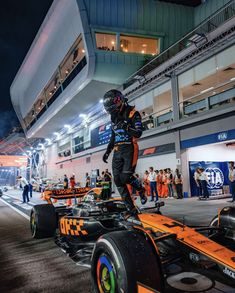 a man riding on the back of a race car