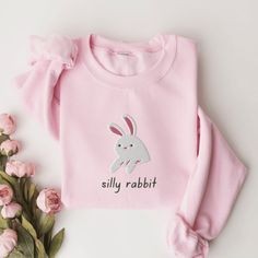 Silly Rabbit Sweatshirt, Embroidered Rabbit Crewneck Sweatshirt, Silly Rabbit Shirt, Funny Sweatshirt, Funny Embroidered Shirt This embroidered silly rabbit crewneck sweatshirt is everything. Perfect to tell everyone that you're a silly rabbit. Please let me know if you would like extended sizing (3X-5X). I have certain size/color combinations available! ✨ 50% cotton, 50% polyester ✨ Pre-shrunk ✨ Classic fit Care: Machine wash: warm (max 40C or 105F) Tumble dry: low Do not iron directly on the print About me: My name is Sarah and I am a graduate student and music teacher! I run this small business myself and enjoy creating fun designs in my free time for some extra cash. I hope that you enjoy these designs as gifts for others or even yourself! REFUNDS AND EXCHANGES All items are made to or Cute Long Sleeve T-shirt With Embroidered Text, Casual Embroidered Long Sleeve T-shirt, Casual Long Sleeve Embroidered T-shirt, Long Sleeve Tops With Embroidered Logo For Spring, Spring Long Sleeve Tops With Embroidered Logo, Cute Crew Neck Sweatshirt With Embroidered Text, Cute Embroidered Long Sleeve Sweatshirt, Cute Long Sleeve Embroidered Sweatshirt, Cute Long Sleeve Embroidered T-shirt