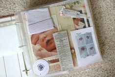 an open binder with pictures and papers on it, including a baby's head