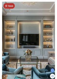 a living room filled with furniture and a flat screen tv mounted on a wall above a glass coffee table