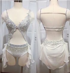 two mannequins are dressed in white and silver outfits with beading on them