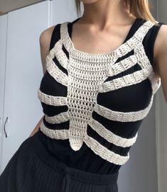 a woman wearing a black and white crochet top