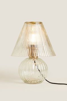 a glass lamp with a cord attached to it