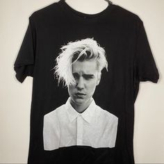 a black t - shirt with a photo of a young man's face on it