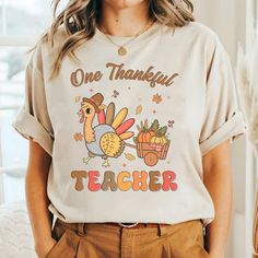 Thanksgiving Teacher Shirts, Fall Teacher Shirts, Teacher Tshirt, Teacher Fall Shirt, One Thankful Teacher Tees, Cute Teacher T Shirt We've got all this and more: - Tshirt material: cotton, polyester - Sweatshirt material: cotton, polyester - Hoodie material: fleece fabric, heavy blend Production and Shipping - Processing Time: 3-5 business days - Shipping time (US): 3-5 business days - Shipping time (WW): 10-15 business days Note - Manual measurement may exist a 1-2cm difference - Actual colors may be slightly different from the image due to different monitor and light effects. - Please contact our support team for detailed information. - No returns or exchanges unless there's a defect or our mistake Thank you for choosing my store! Funny Cotton Tops For Fall, Thanksgiving Teacher Shirts, Teacher Christmas Shirts, Fall Teacher Shirts, Teacher Tees, Teacher Christmas, Hoodie Material, Fall Shirt, Teacher Tshirts