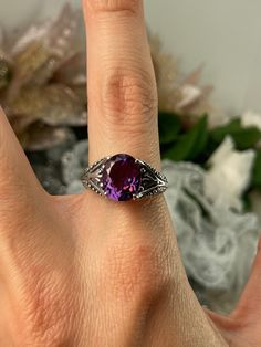 "Natural Purple Amethyst Ring Small Oval Gothic Design#85 Custom made This is a brand new stunning Gothic/Renaissance inspired sterling silver filigree ring. The flawless oval-cut high-quality natural purple amethyst is 11mm (7/16th of an inch) by 9mm (just shy of 3/8\" inch) in dimension... The inside of the band is marked 925 for sterling. Notice the beautiful filigree swirl like the craftsmanship of the silver setting. This is an exquisite rendition of a Gothic design filigree ring.... and is Classic Oval Amethyst Ring With Accent Stones, Oval Amethyst Ring With Accent Stones For Anniversary, Classic Oval Amethyst Ring With Prong Setting, Oval Amethyst Gemstones For Promise Rings, Purple Oval Topaz Ring For Anniversary, Oval Purple Topaz Ring For Anniversary, Oval Amethyst Gemstone With Center Stone, Purple Oval Topaz Anniversary Ring, Oval Purple Amethyst Ring With Center Stone