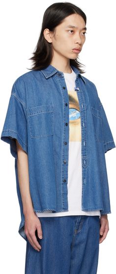 Oversized non-stretch denim shirt. · Logo patch at spread collar · Logo flag at button closure · Patch pockets · Logo patch at front · Droptail hem · Vented side seams · Dropped shoulders · Twin pleats at back yoke · Contrast stitching in white Supplier color: Indigo Blue Denim Shirt With Patch Pockets, Maison Mihara Yasuhiro, Maison Mihara, Contrast Stitch, Half Sleeve, Denim Shirt, Half Sleeves, Stretch Denim, Patch Logo